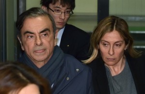 This picture taken on April 3, 2019 shows former Nissan Chairman Carlos Ghosn (L) and his wife Carole (L) leave the office of his lawyer Junichiro Hironaka in Tokyo. - Former Nissan boss Carlos Ghosn will remain in custody until at least April 14, a Japanese court ruled on April 5, 2019, as prosecutors quiz him over fresh allegations of financial misconduct. (Photo by Kazuhiro NOGI / AFP)